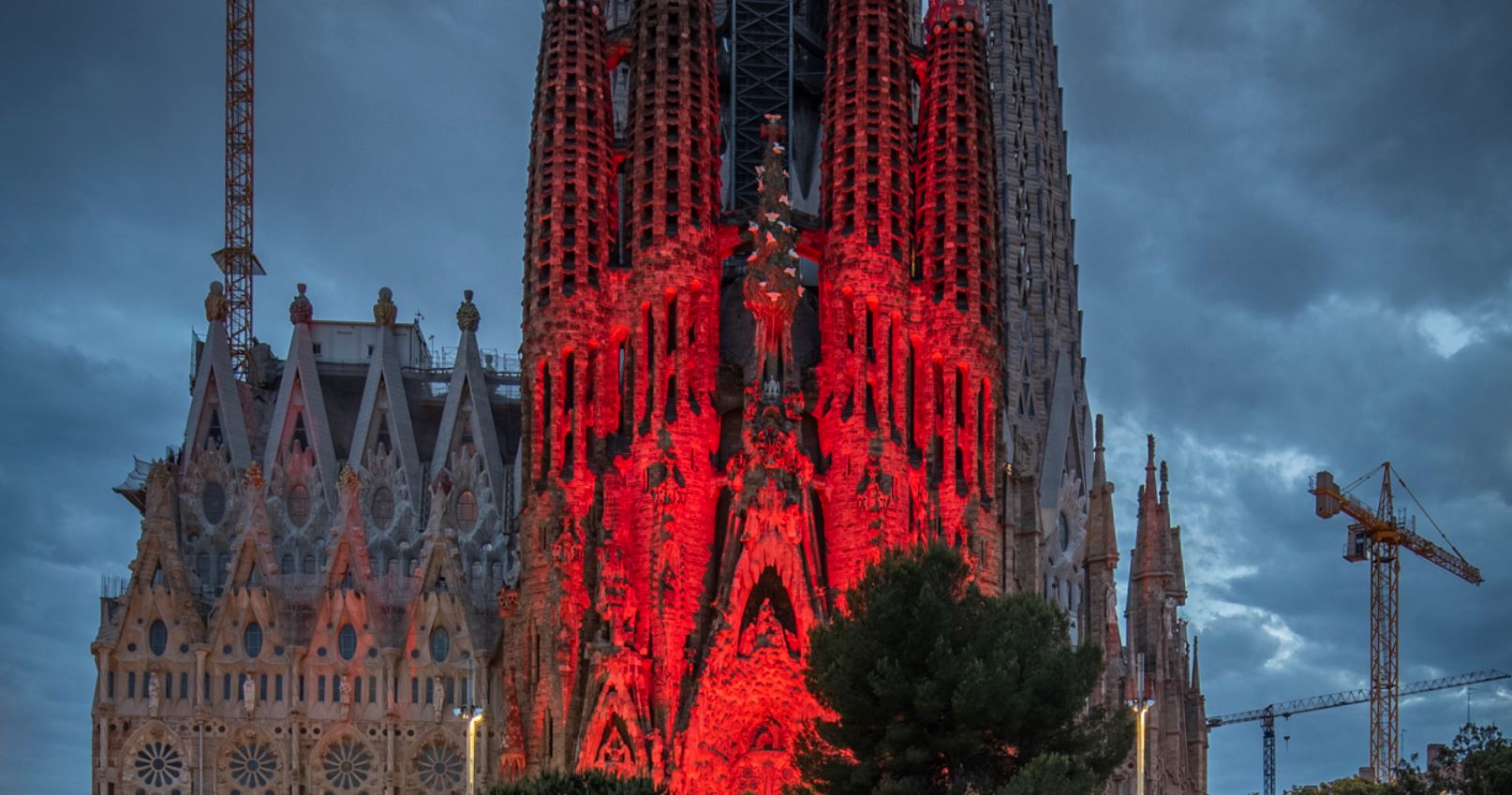The front of the iconic Sagrada Familia lit up in red lights for charity (photo courtesy of Sagrada Familia)